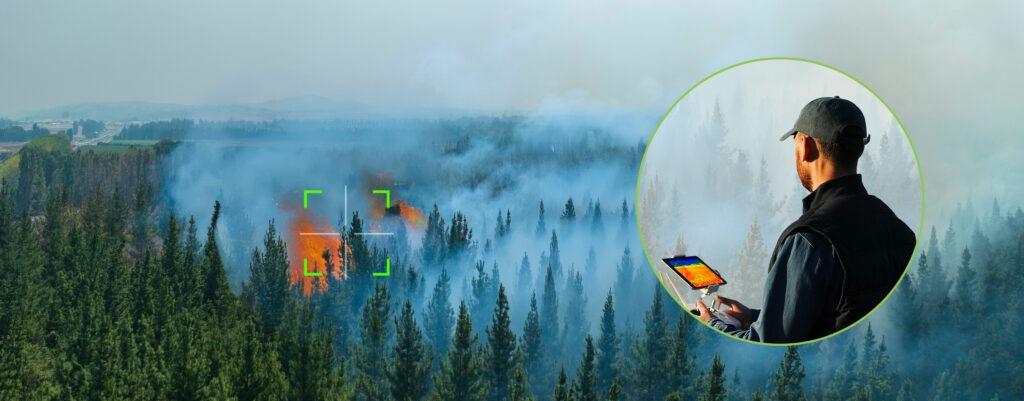 UAV drone flying over forest fire with smoke in mountainous region